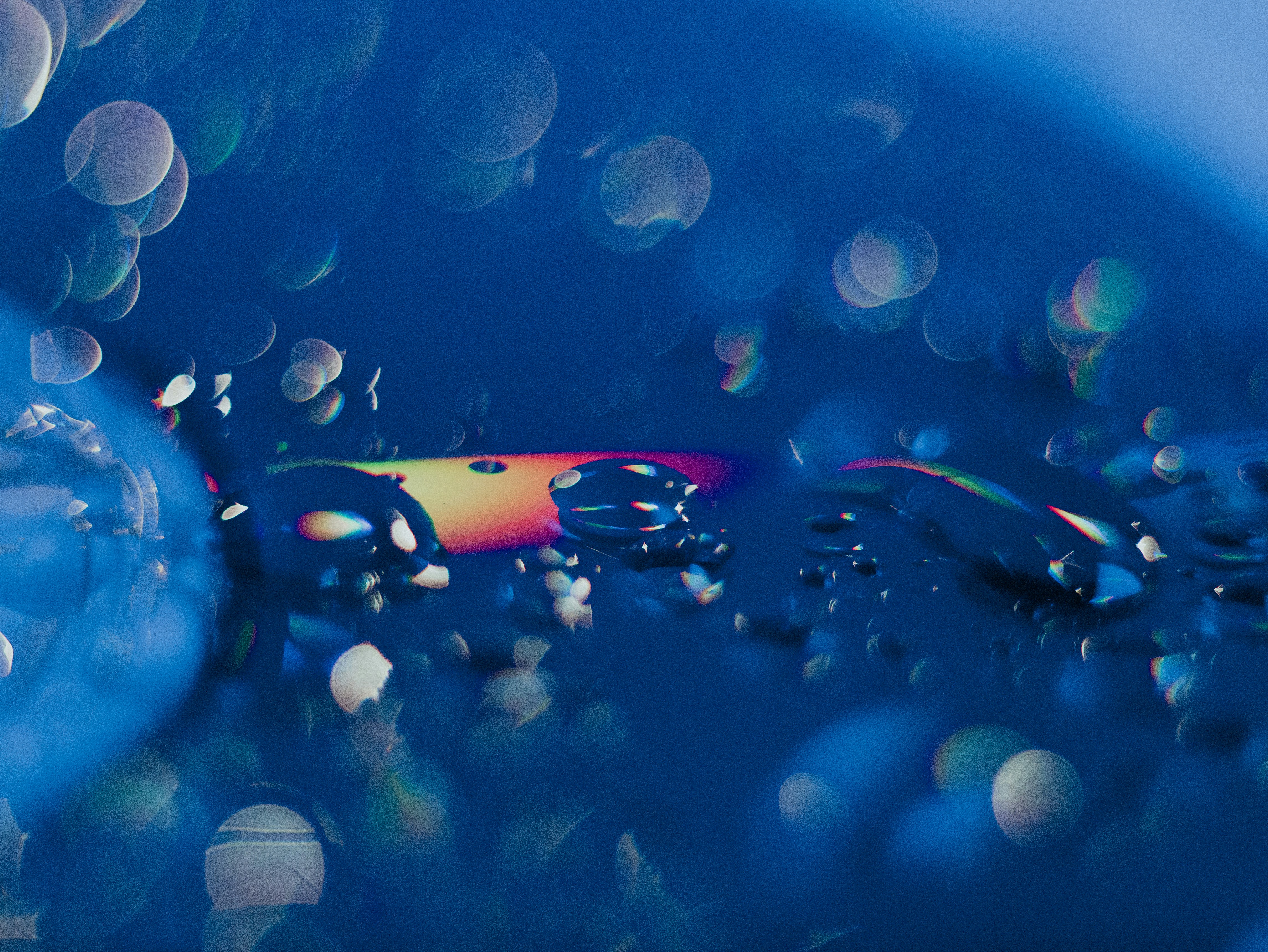 a close up of water droplets on a blue surface