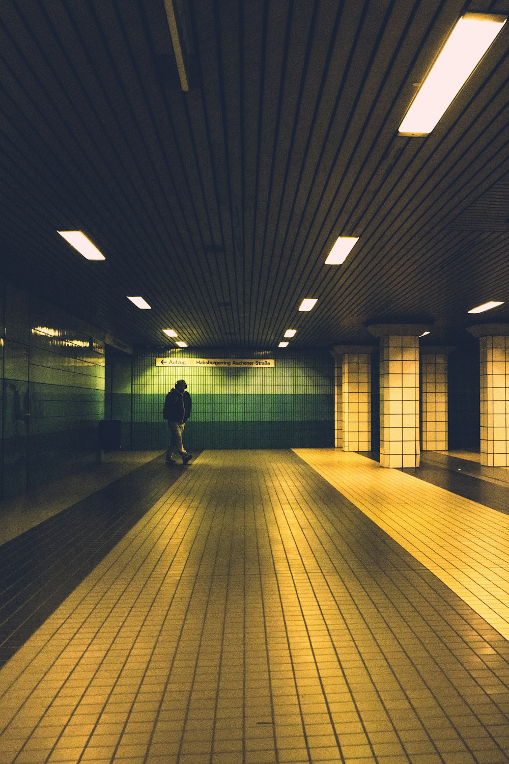 a person standing alone in a dimly lit room