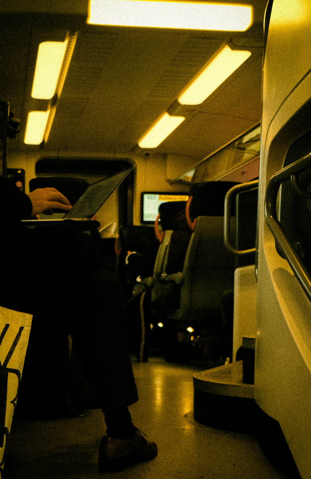 a person sitting on a train next to a window