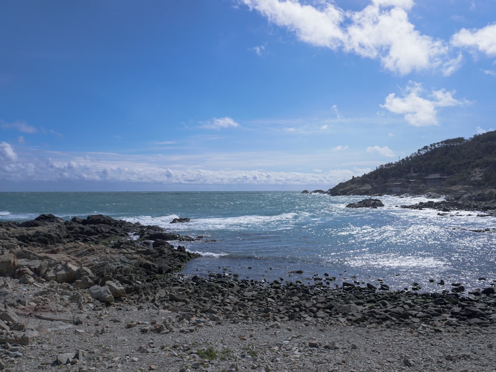 a view of the ocean from a rocky shore