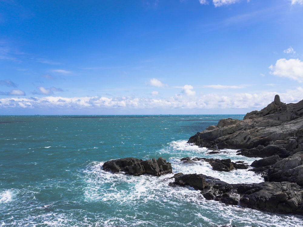 a view of the ocean from a rocky shore