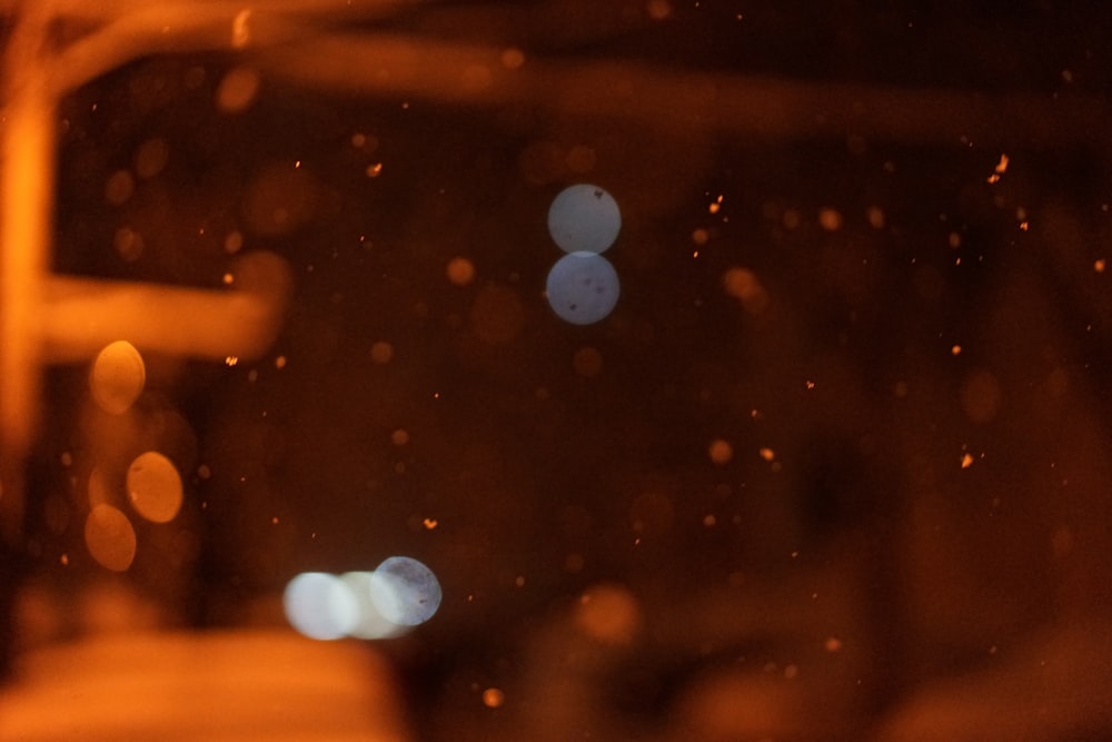 a blurry photo of a street light in the rain