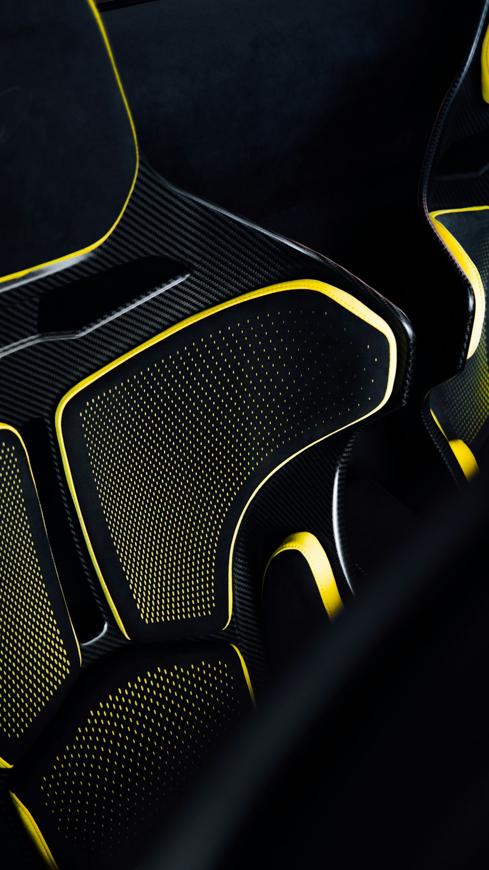 a close up of a black and yellow seat