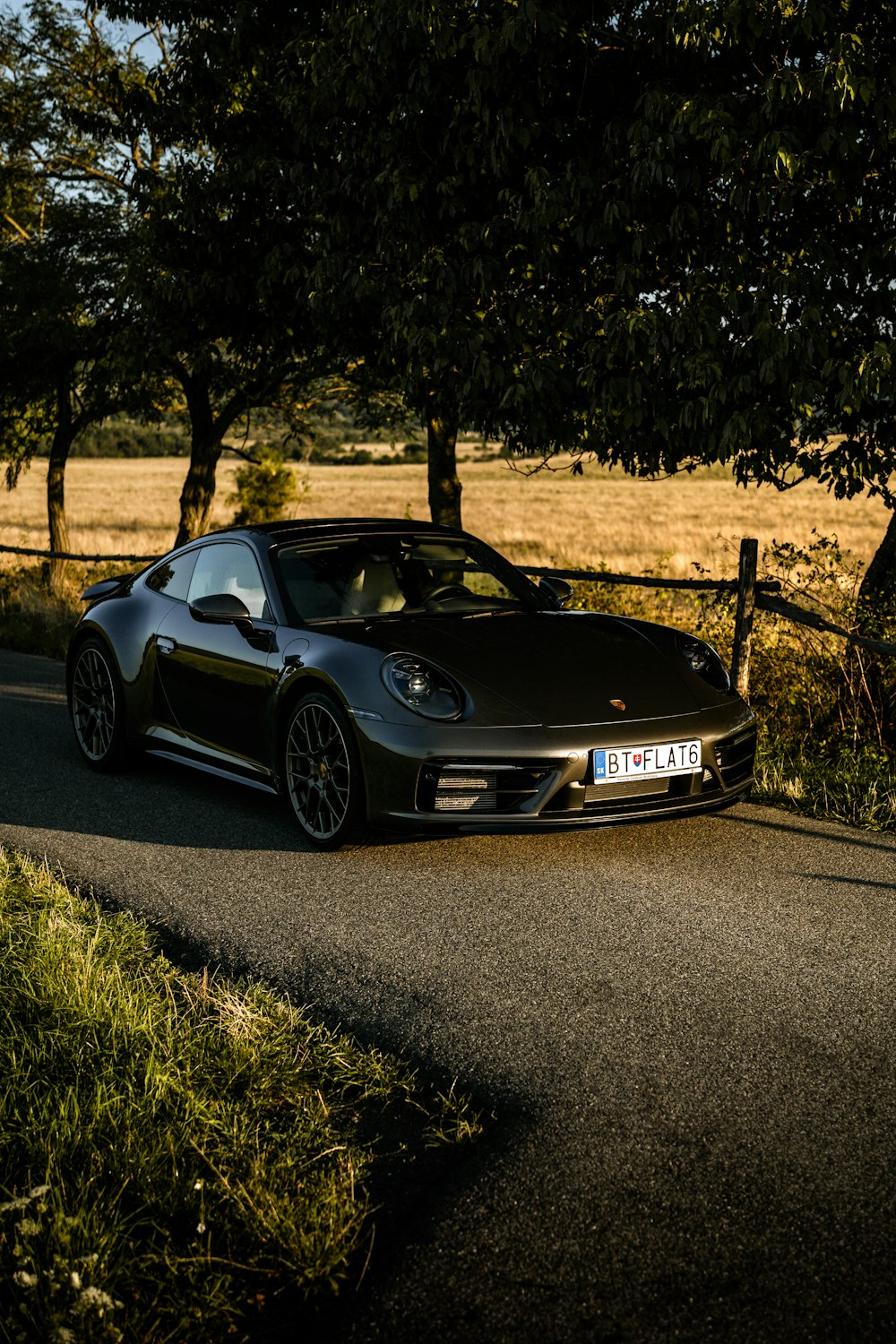 a black sports car parked on the side of a road