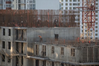 a building under construction with a crane in the background