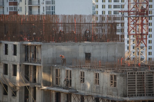 a building under construction with a crane in the background