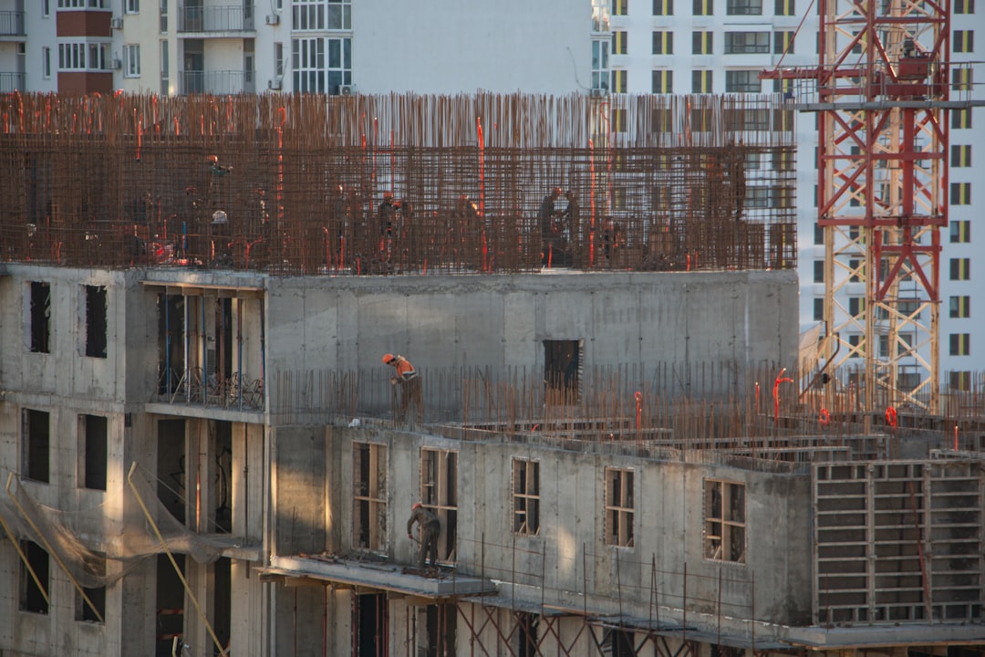a building under construction with a crane in the background,