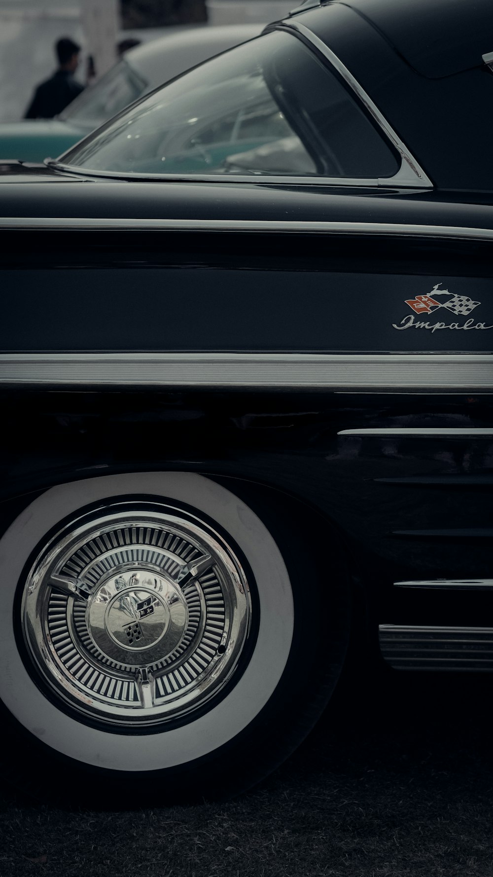 a close up of a black car with chrome rims