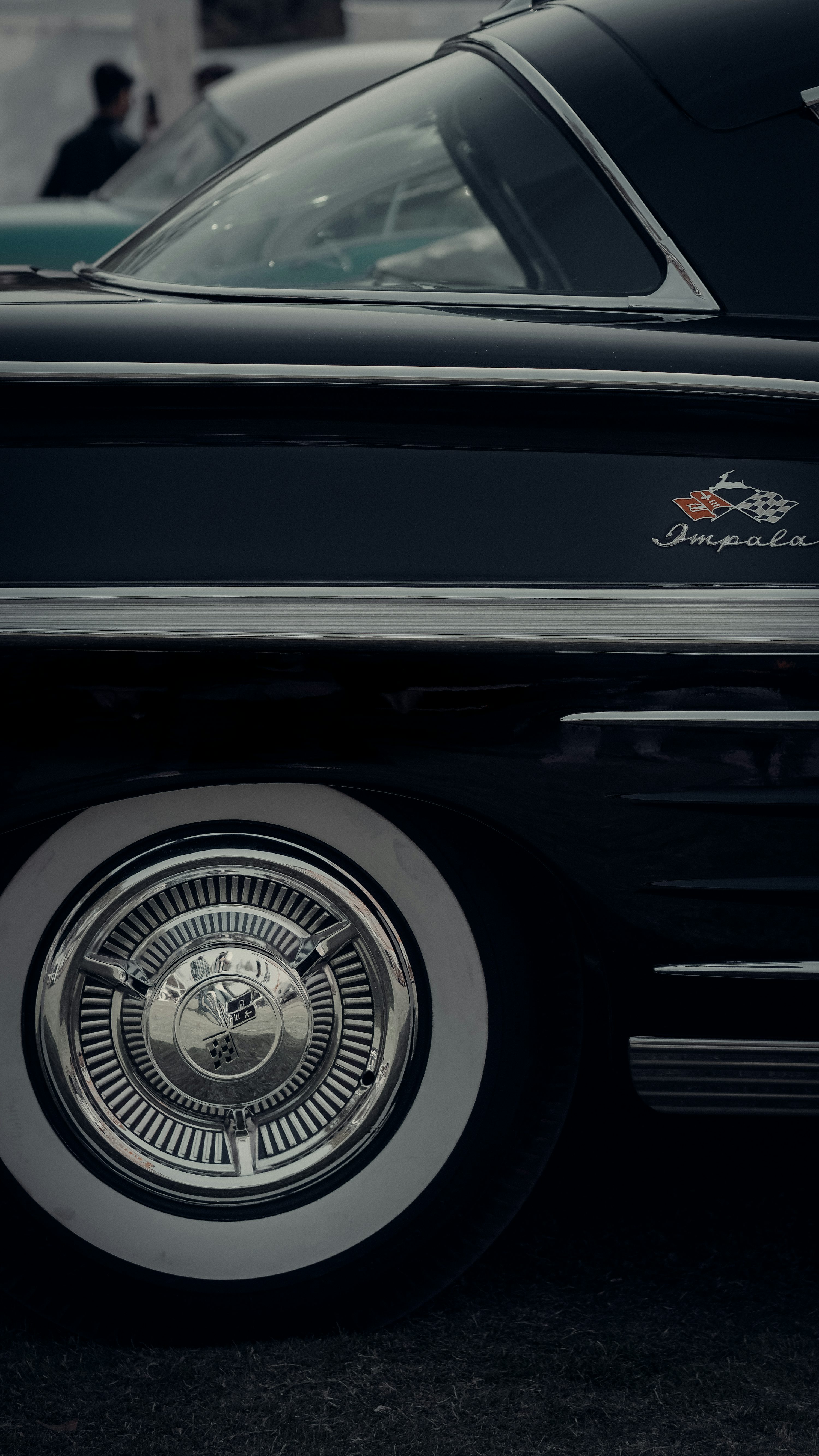 a close up of a black car with chrome rims