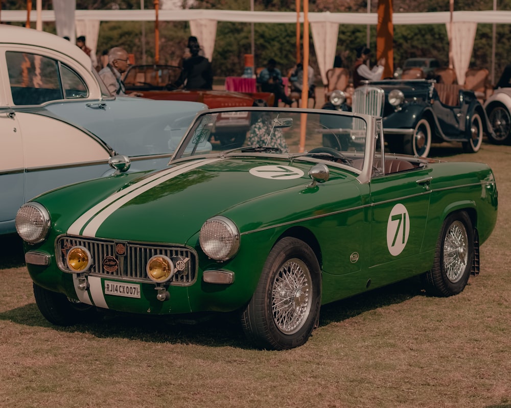 a green sports car parked in a field