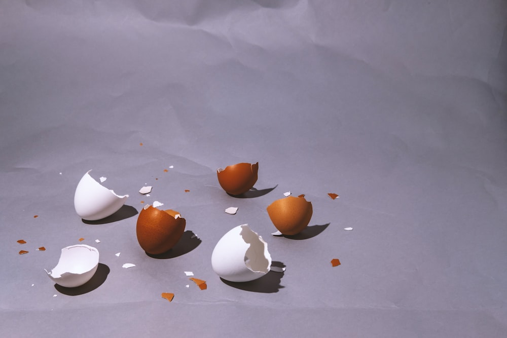 a group of broken eggs sitting on top of a table