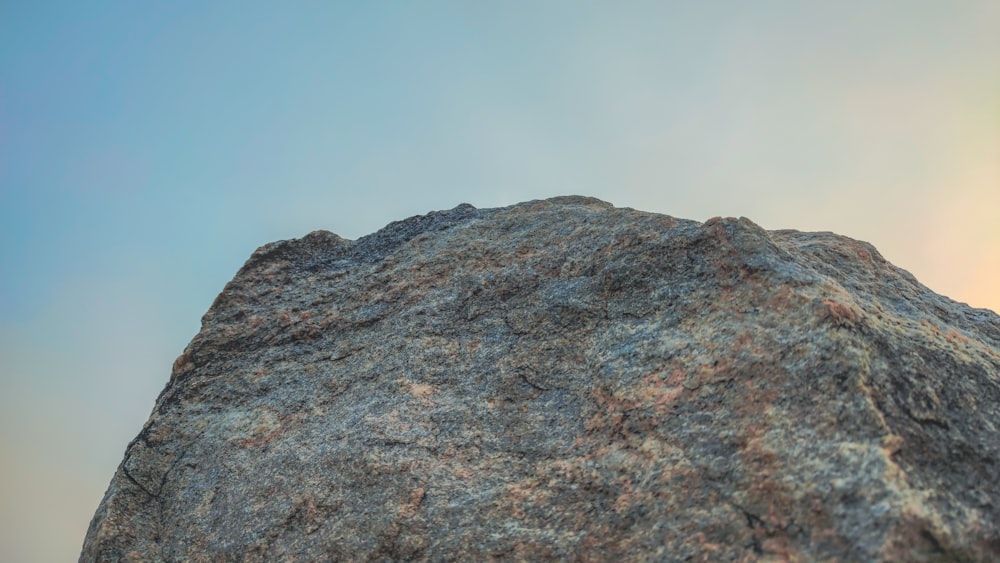 a close up of a rock with a sky background