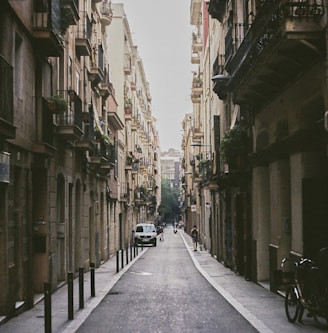 a narrow city street lined with tall buildings