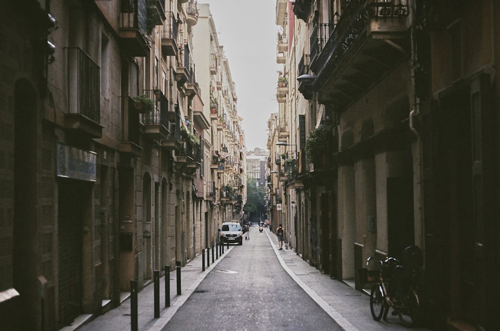 a narrow city street lined with tall buildings