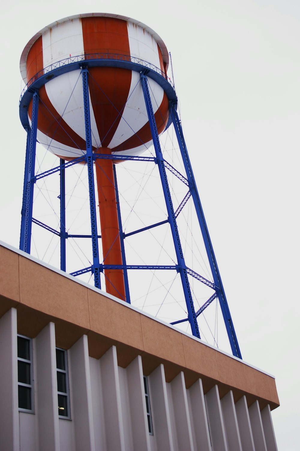 a tall water tower with a red and white striped top