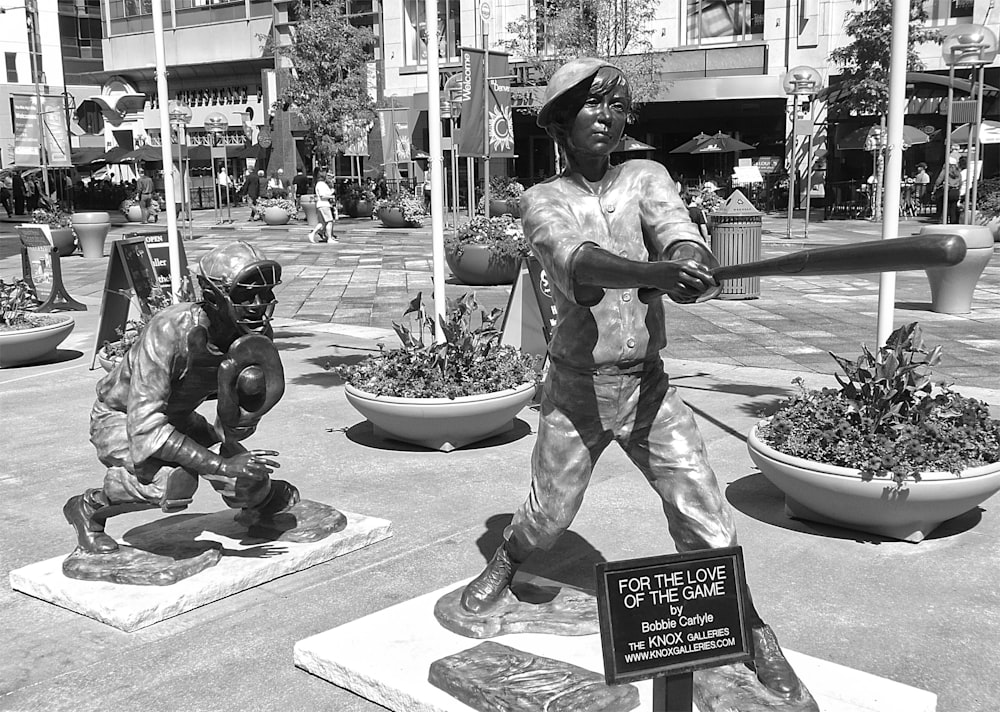 a statue of a baseball player holding a bat