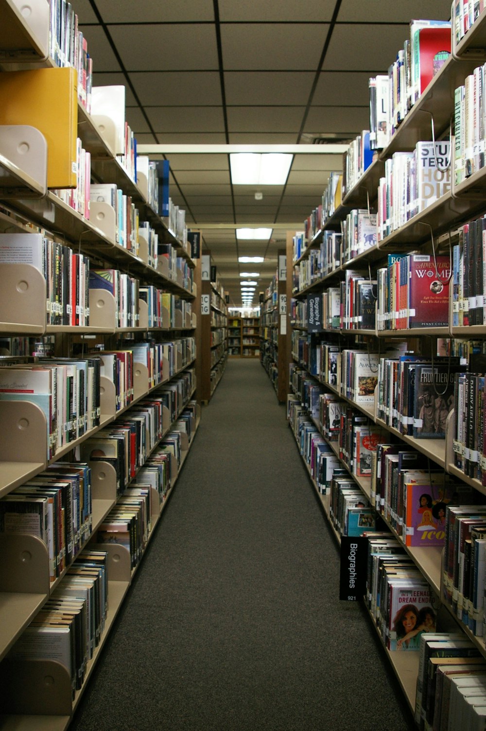 a long row of shelves filled with lots of books