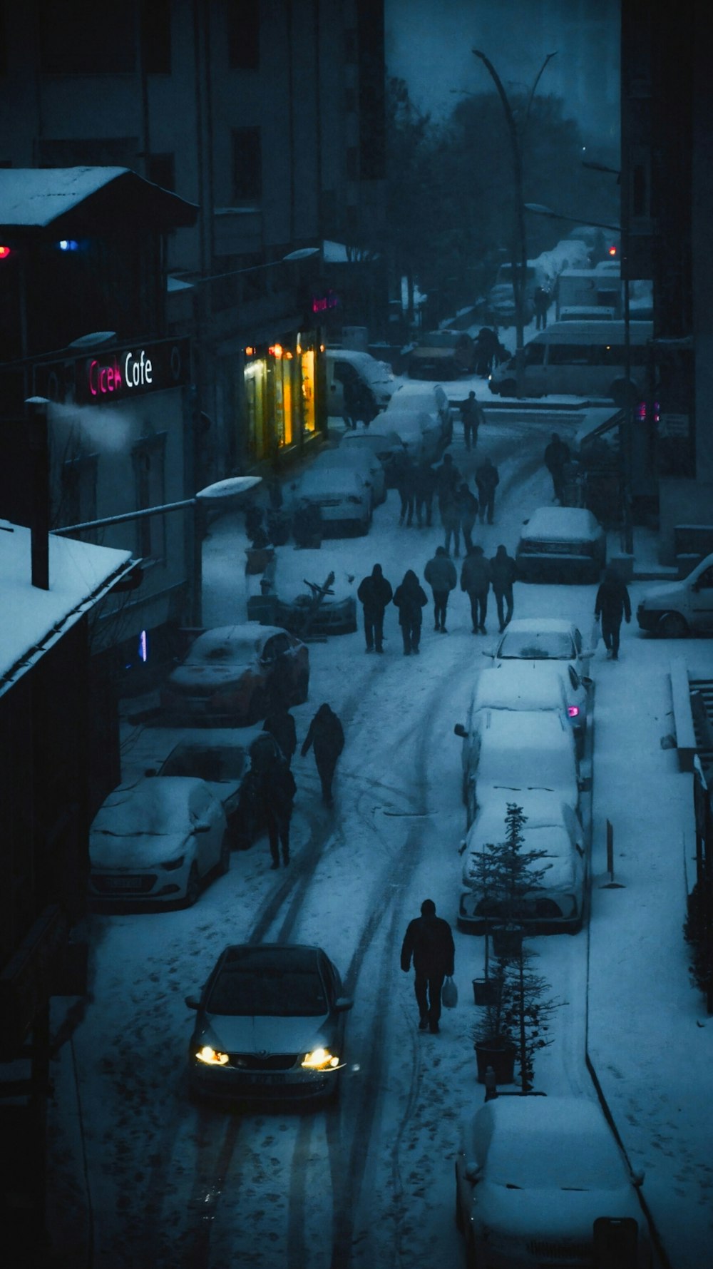 a group of people walking down a snow covered street