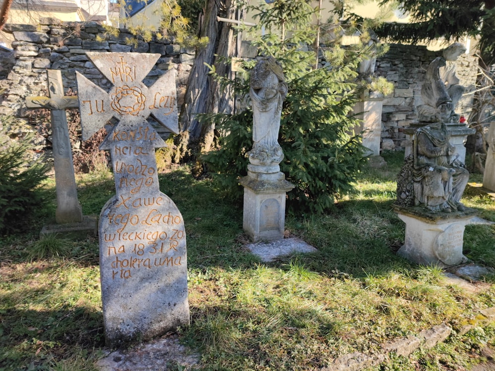 a group of tombstones in a grassy area