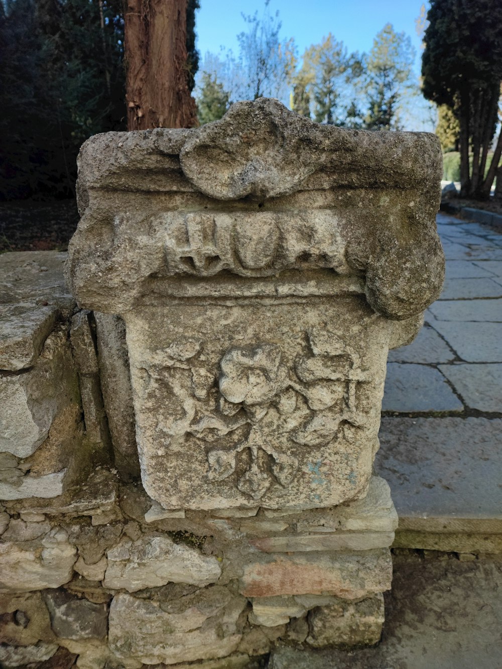 a stone pillar sitting on top of a sidewalk