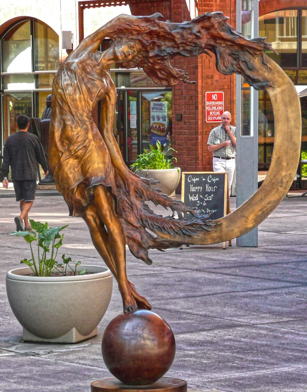 a statue of a woman is in a potted planter