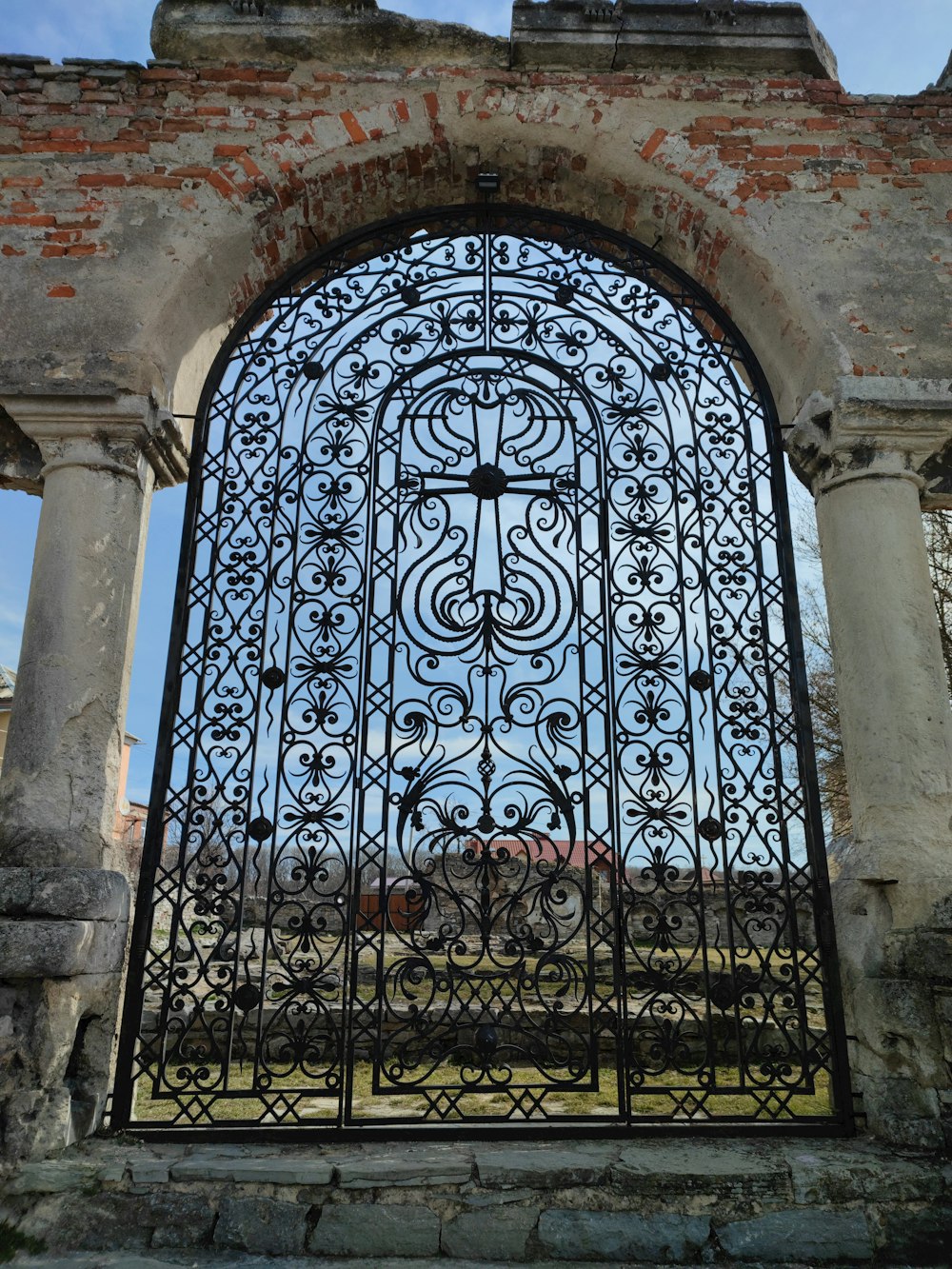 a large iron gate with a clock on top of it