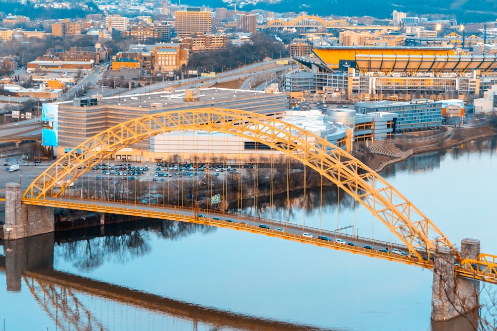 a bridge over a body of water with a city in the background