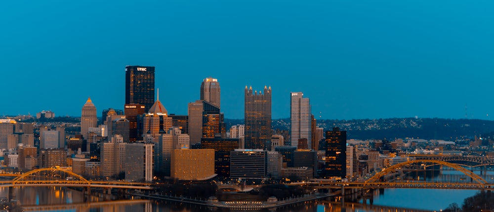 a view of a city at night with a bridge in the foreground