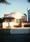 a large house with a white fence in front of it