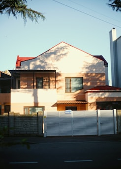 a large house with a white fence in front of it