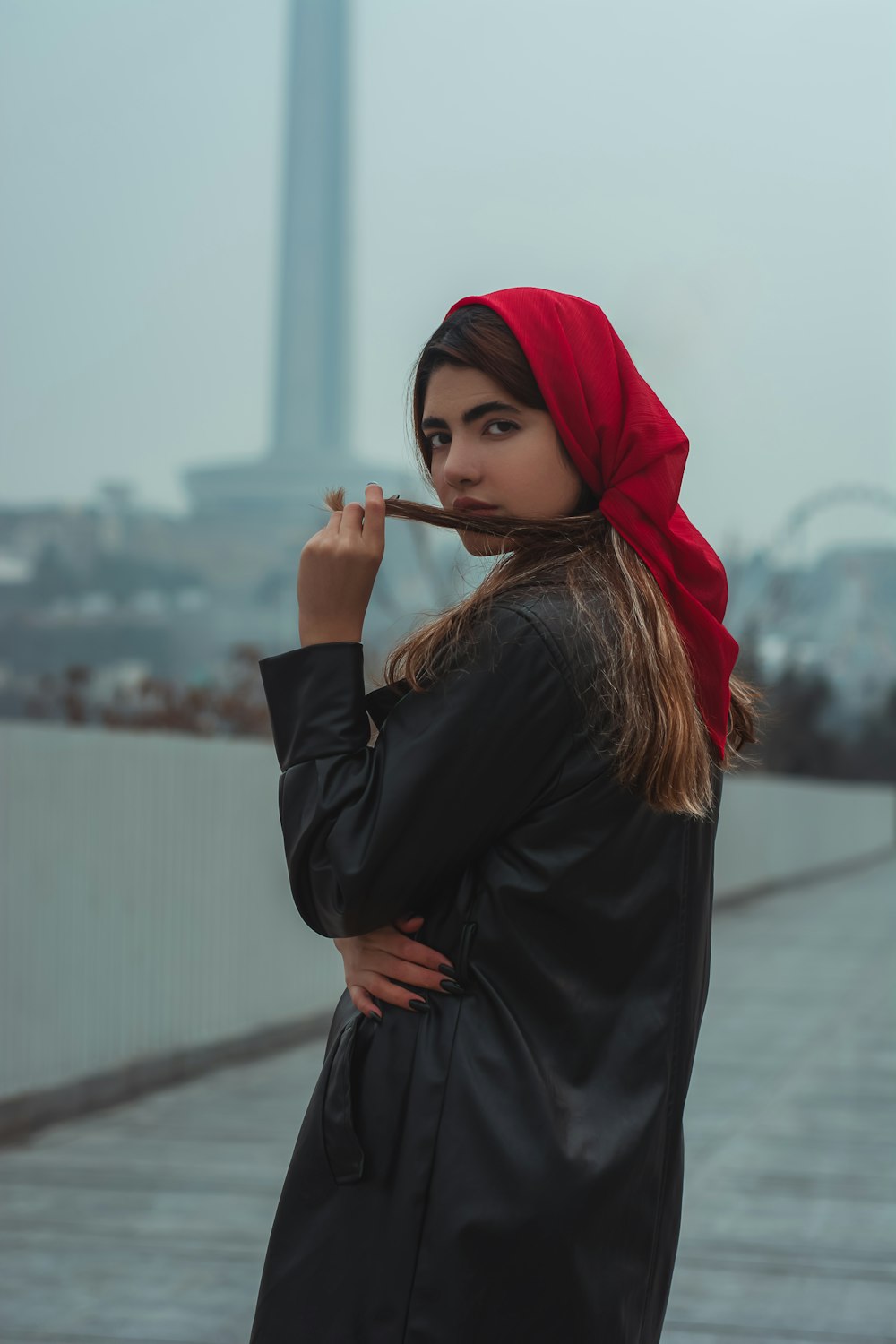 a woman in a red scarf smoking a cigarette