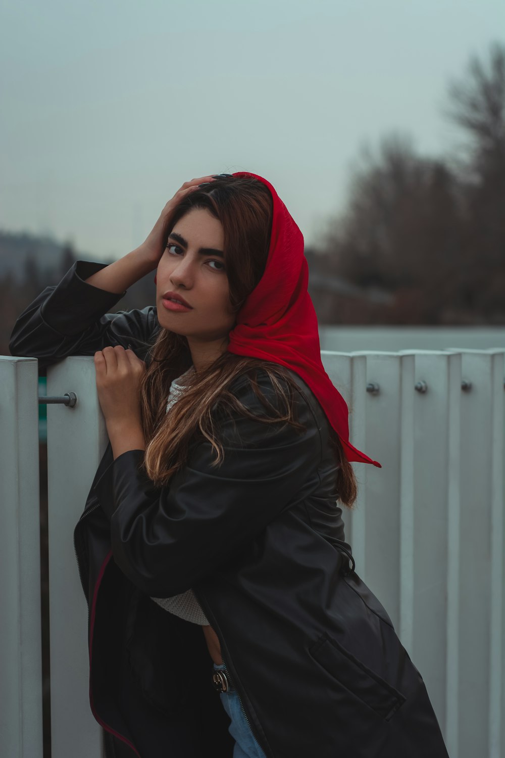 a woman wearing a black jacket and a red scarf