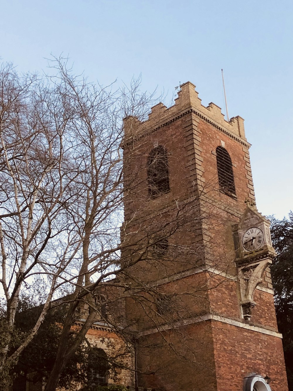 a tall brick building with a clock on it's side