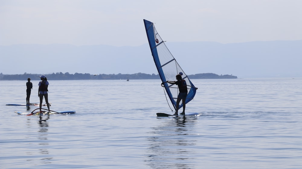 a couple of people on surfboards in the water