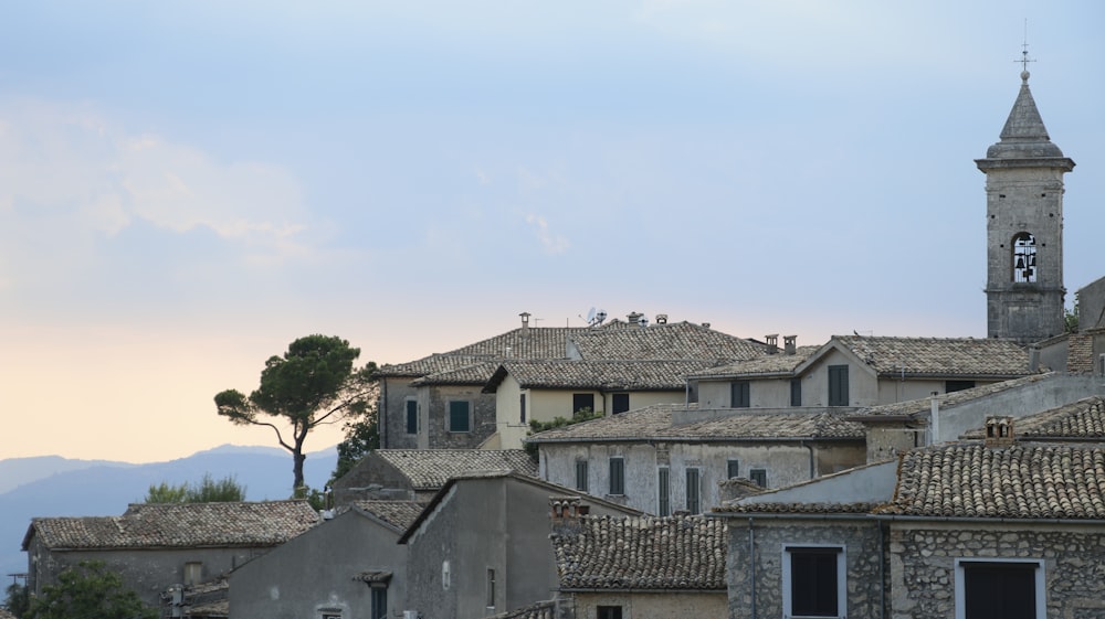 a view of a town with a clock tower in the background