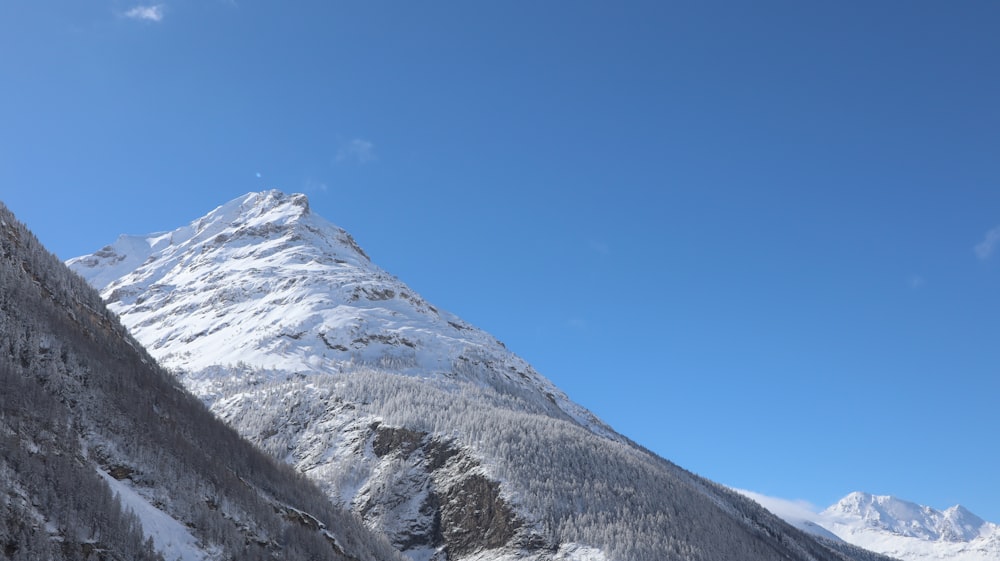 a snow covered mountain with a clear blue sky