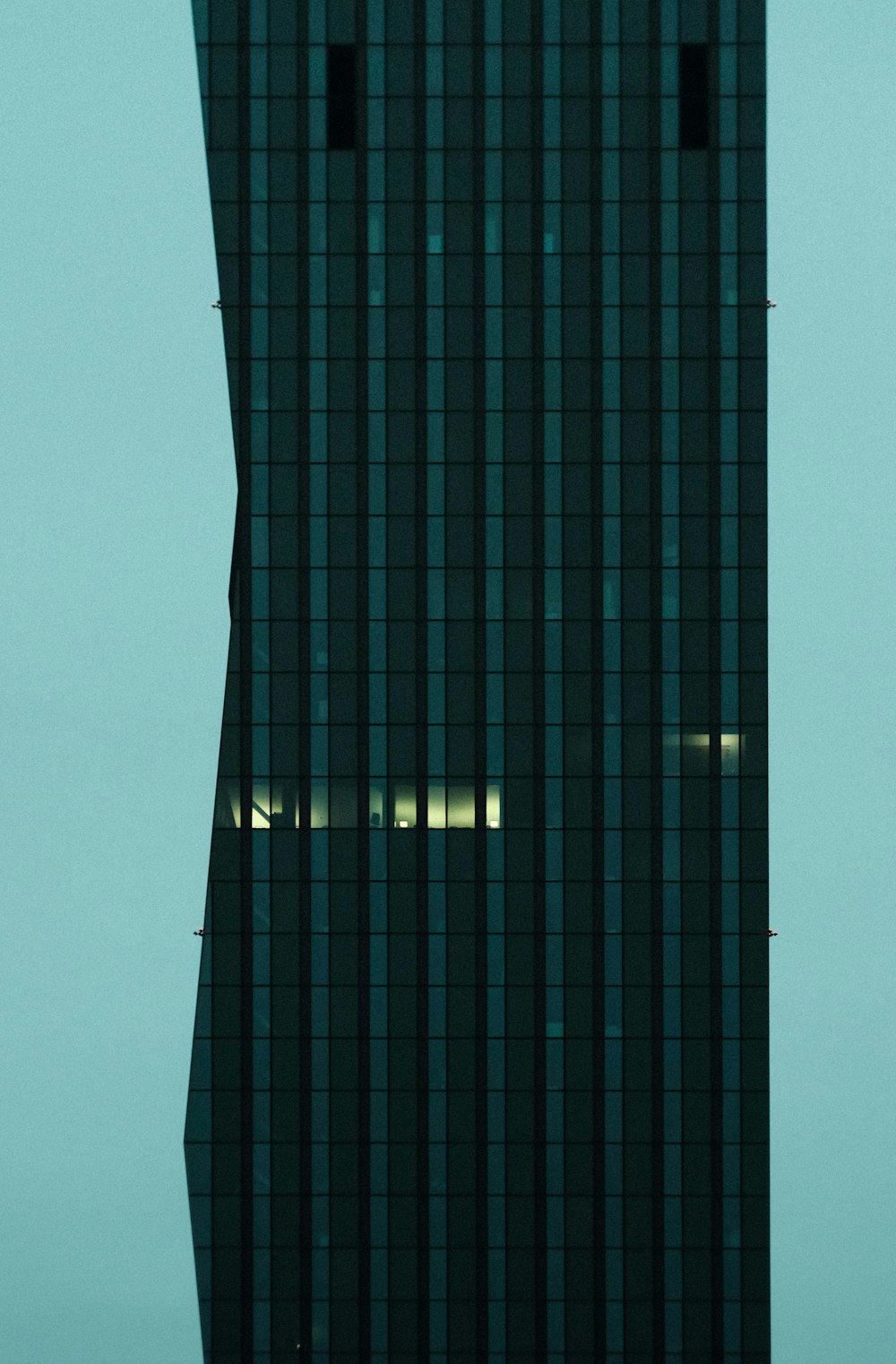 a very tall building with a clock on it's side