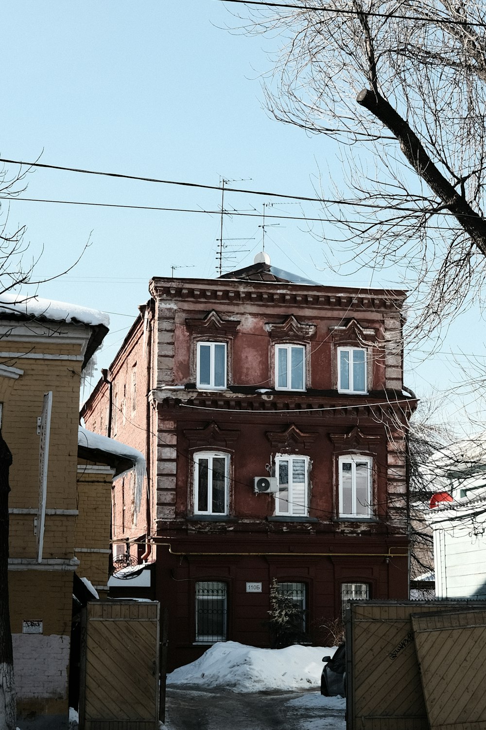 a red brick building sitting on the side of a snow covered road