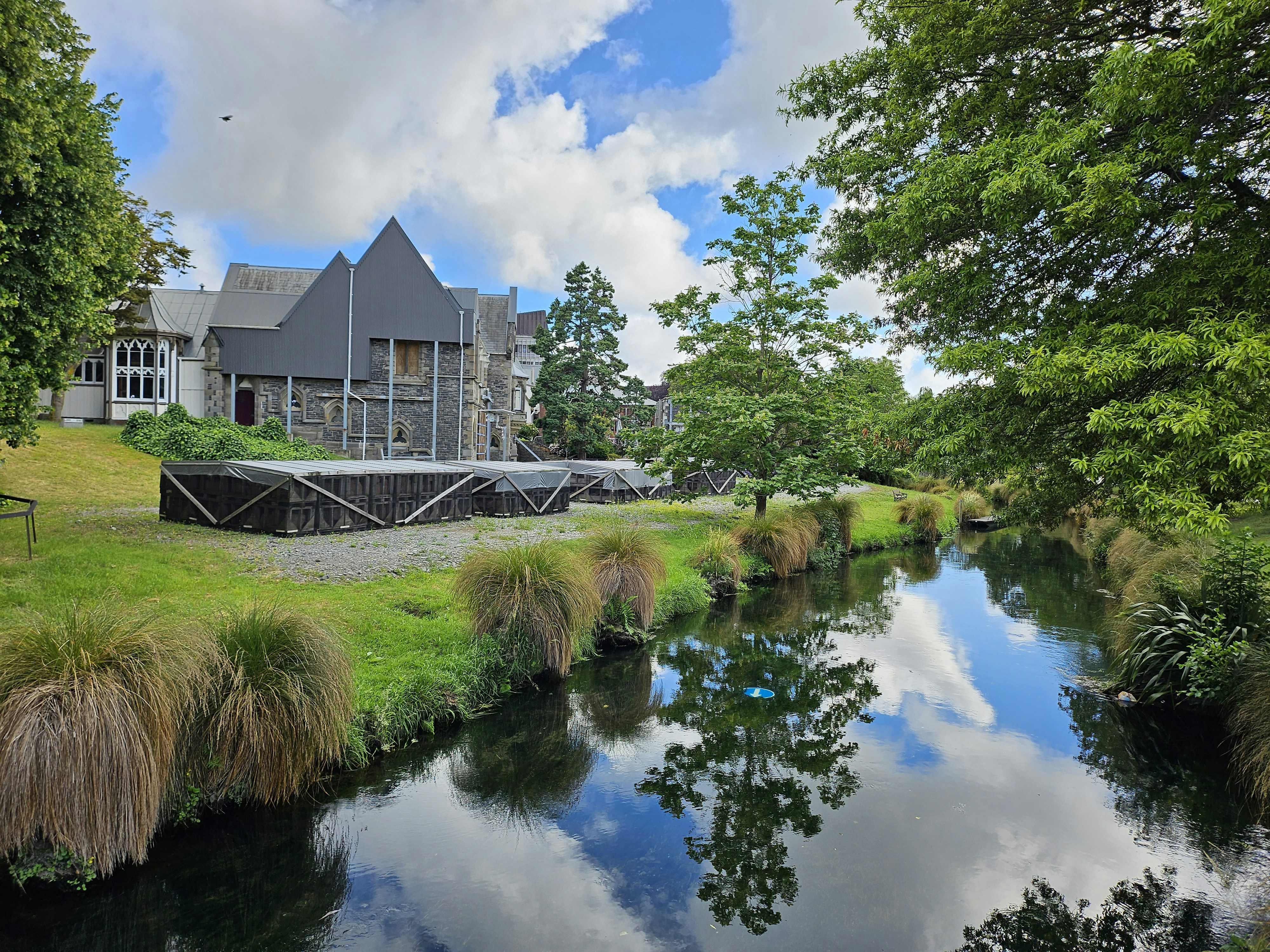 a large house sitting on top of a lush green hillside