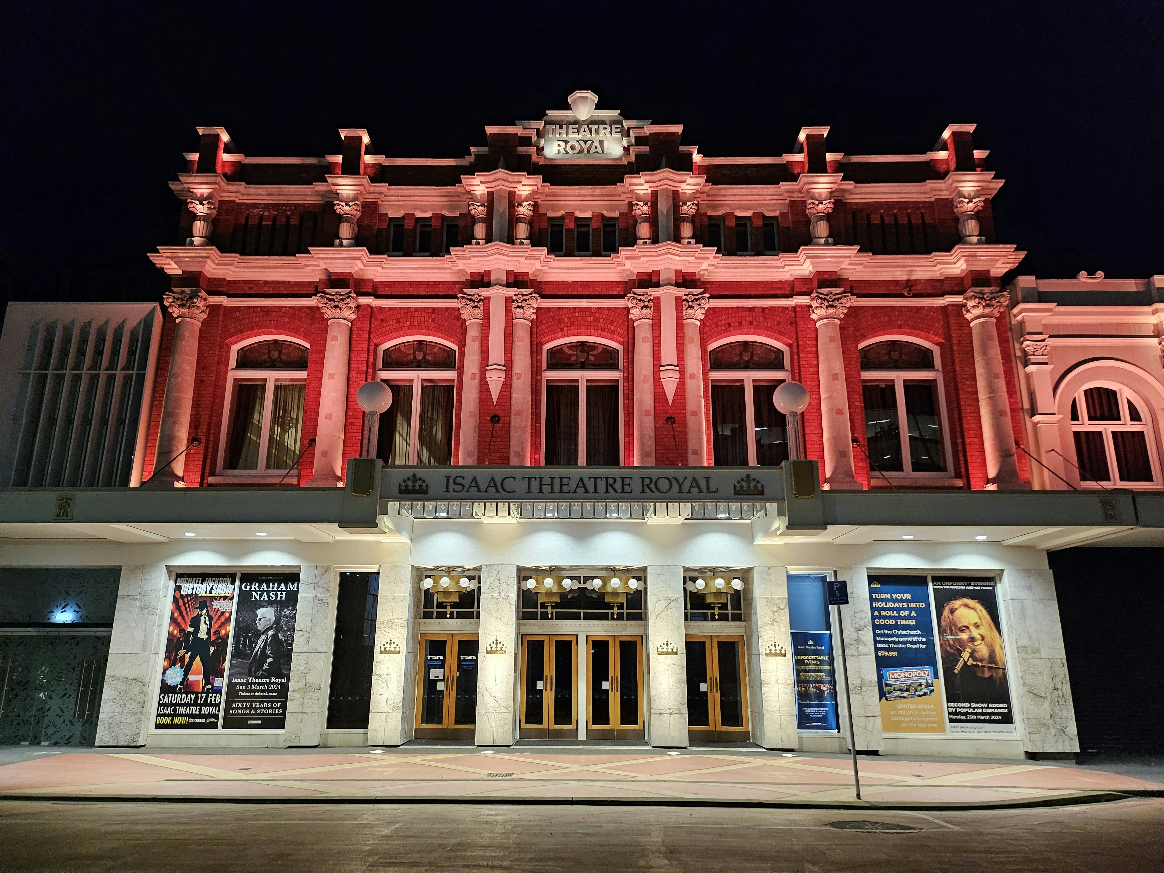 a red building with a clock on the top of it