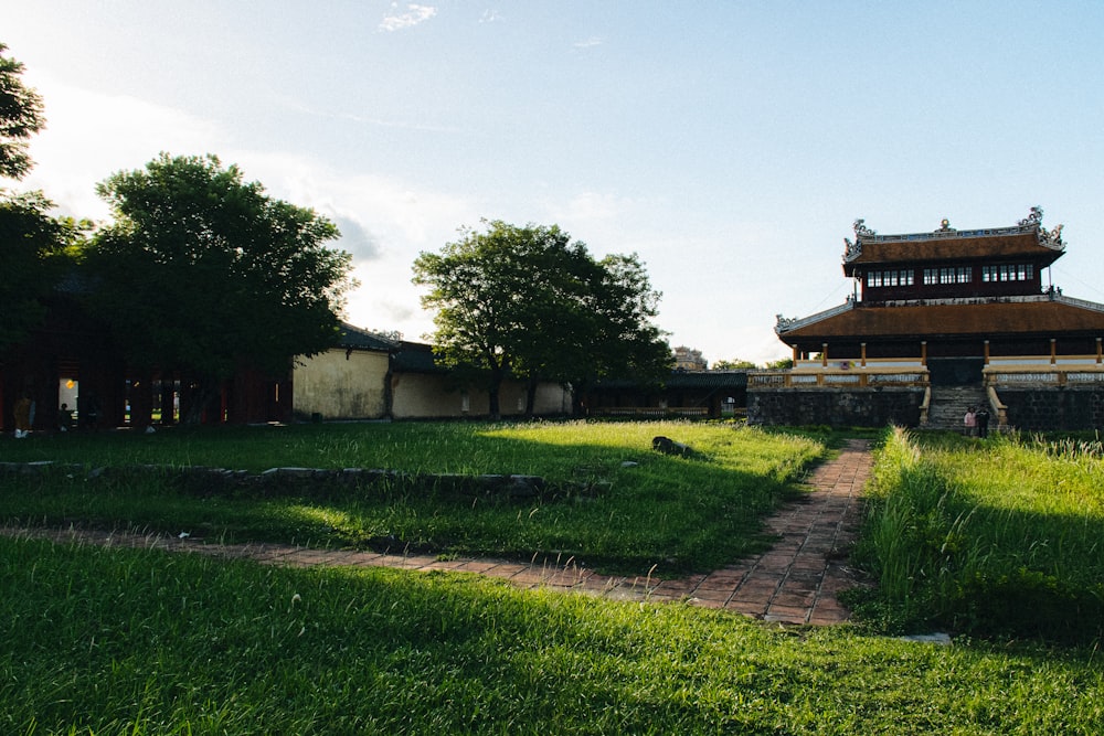 a grassy field with a building in the background