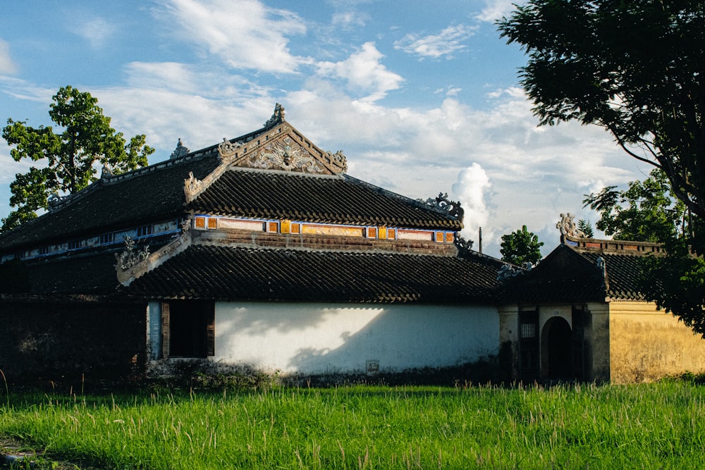 an old building with a green field in front of it