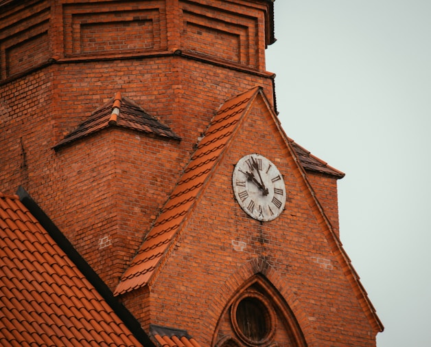 a clock on the side of a brick building