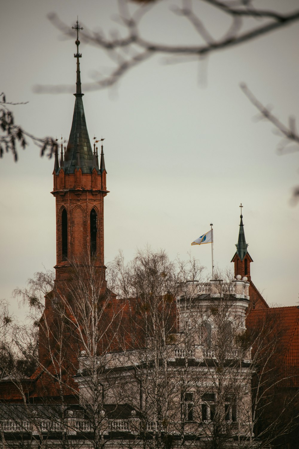 a building with a clock tower and a flag on top