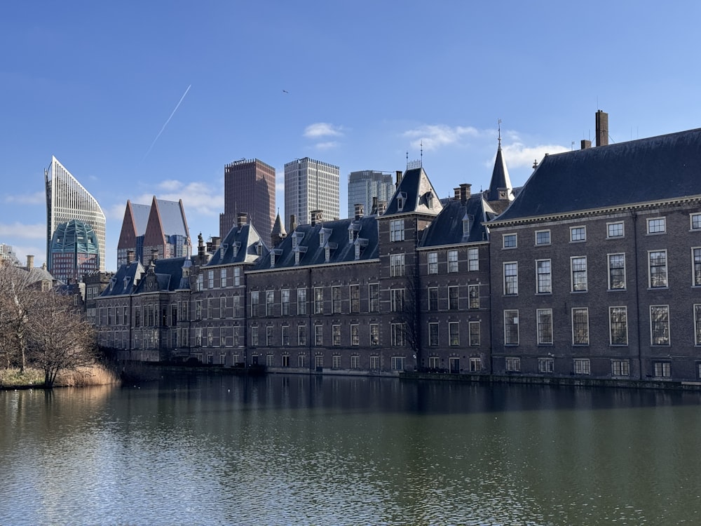 a large body of water with buildings in the background