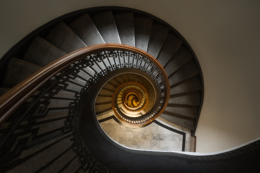 a spiral staircase in a building with a light at the top