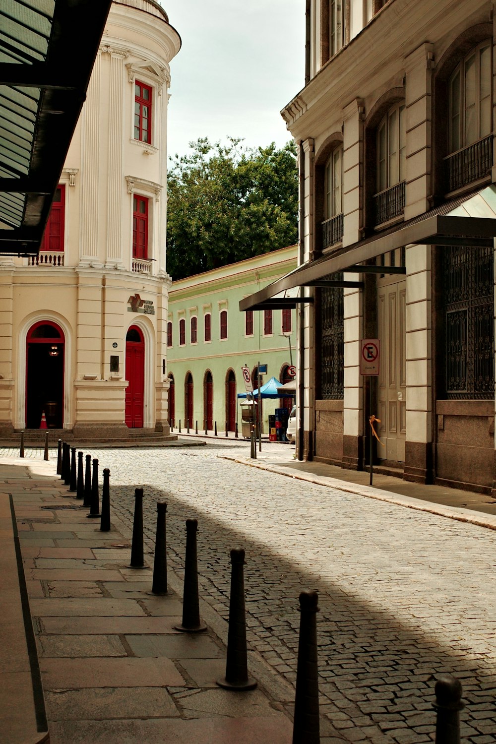 a cobblestone street lined with tall buildings