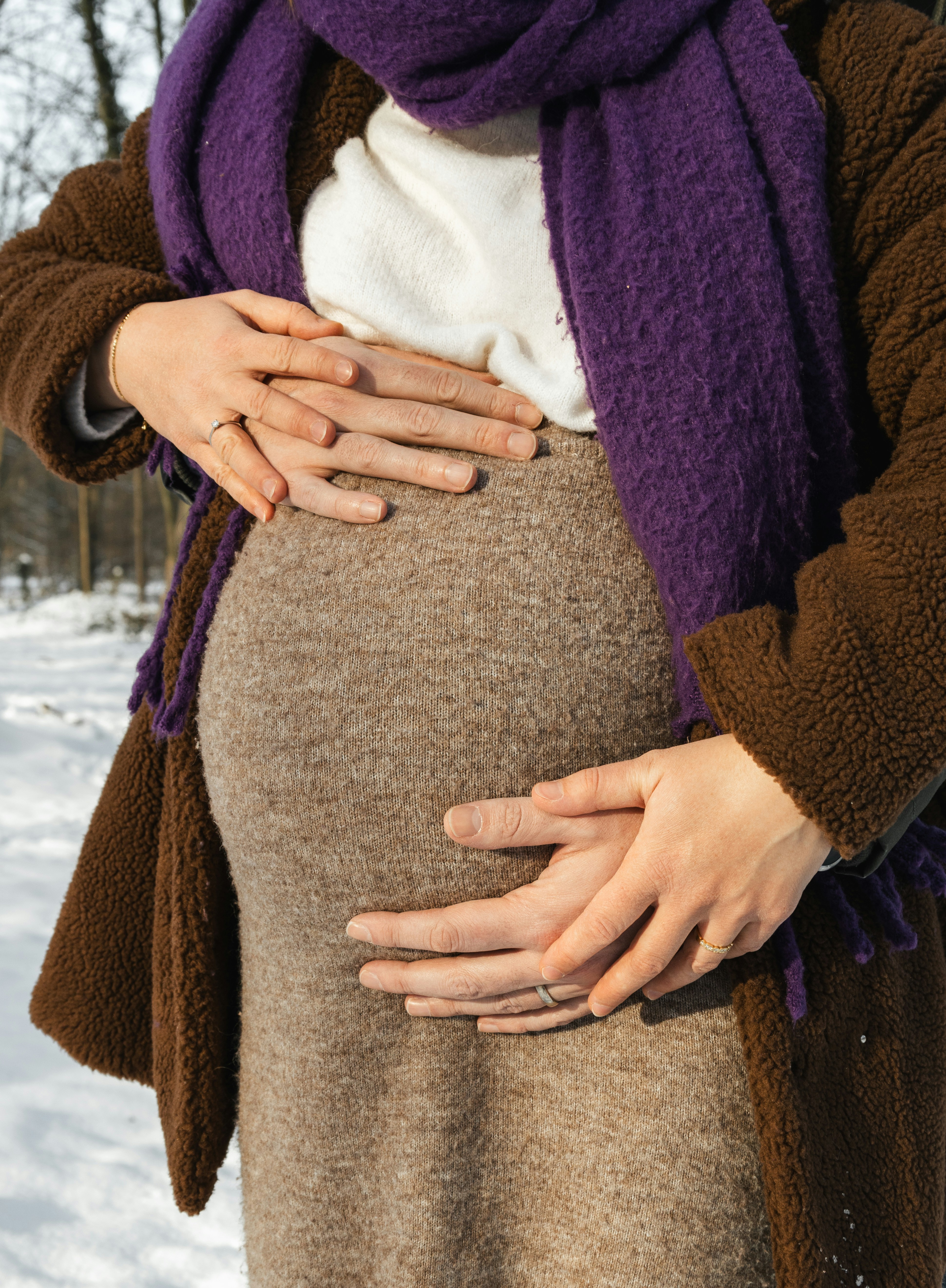 a pregnant woman with her hands on her stomach