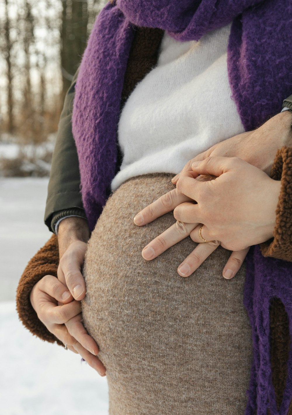 a woman wearing a purple scarf and a brown skirt