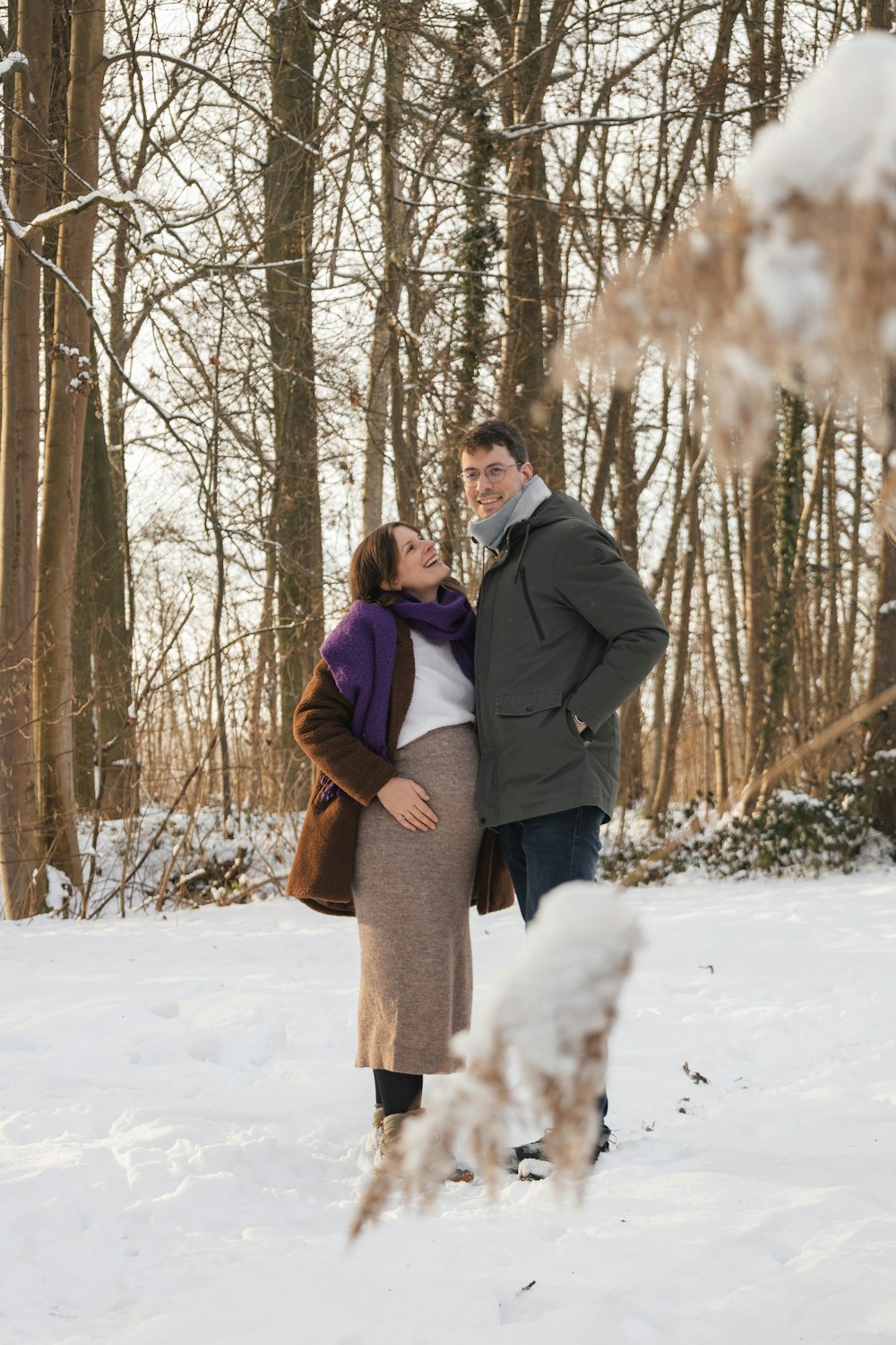 a man and a woman standing in the snow